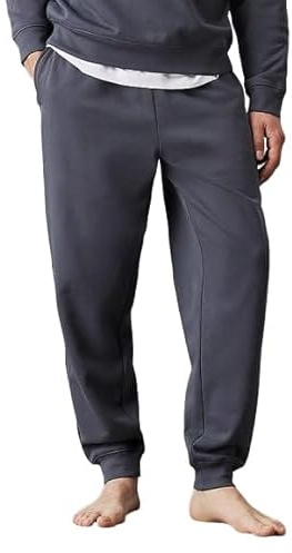 Calvin Klein Pantalón de chándal Lounge hombre forro polar de algodón puro, suave interior peinado. Cintura elástica, cordón interior, bolsillos laterales. Escudo tono sobre tono sobre tono sobre el