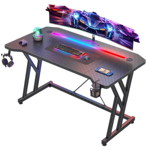 Klyvvo Scrivania Gaming LED 120x60cm, Tavolo Computer con Banda RGB, Tavolo Gaming Ergonomica, Gamer con Superficie in Fibra Carbonio, Scrivania per Computer con Porta Tazza e Gancio per Cuffie, Nero
