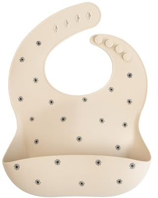 Mushie Baby Silicone Bib | Adjustable Fit Waterproof Bibs | Easy Wipe Baby Feeding Bibs | 4 Adjustable Sizes with Deep Front Pockets | 100% BPA and Phthalate Free (Black Daisy)