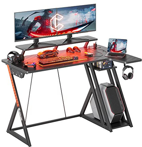 CubiCubi Gaming Desk with LED Lights & Power Outlets, 100 cm L Shaped Carbon Fiber Surface Desk with Storage Shelves, Small Corner Computer Desk with Monitor Shelf, Black