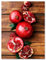 wandmotiv24 Leinwandbild Obst & Gemüse, Hochformat, Granatapfel, Holztisch, Küche M0386