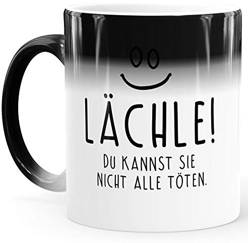 MoonWorks® Zaubertasse Farbwechsel Tasse lustiger Spruch lächle du kannst sie nicht alle töten Smiley Bürotasse weiß Magic-Tasse